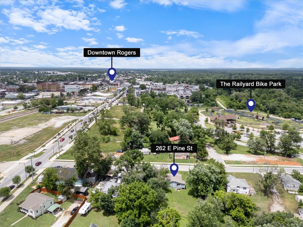 All about that LOCATION! Prime .25 lot just steps from Downtown Rogers and the Railyard Bike Park. The 880(+/-)  sq ft house would make the perfect starter home or rental. HVAC is 2026. Stove is 2025. Property is zoned Neighborhood High Density which supports multiple building types. Check the Rogers zoning map for more details. Property being sold as-is. 3 parking at the street on the west side boundary line - marked with an orange stake.