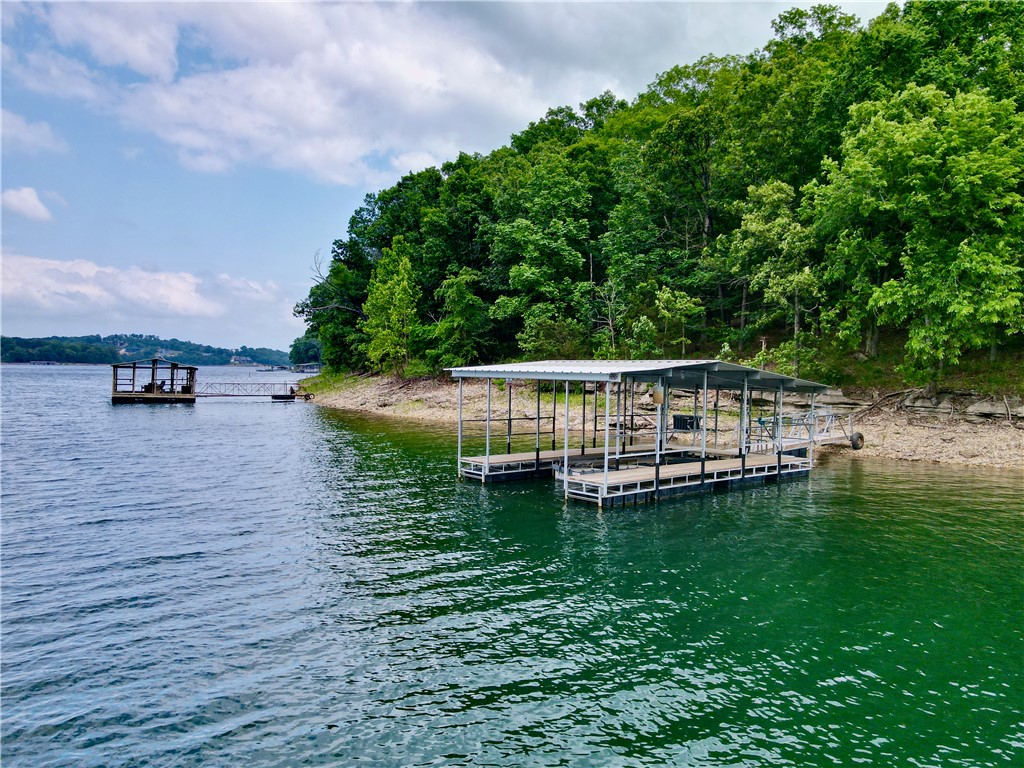 Lakefront living at its finest on beautiful Beaver Lake! This stunning lake home is tucked in a peaceful cove and includes a private boat dock with lift and solar power—perfect for easy days on the water.

Enjoy the outdoor lifestyle with a spacious firepit area, two large decks with breathtaking views, and direct lake access for boating, fishing, and swimming. Ideal for entertaining or relaxing at sunset, this property offers the ultimate lake retreat.

Turn-key and move-in ready, the interior features granite countertops, extensive custom woodwork, and a whole-house generator for year-round peace of mind. The fully refinished basement includes a bonus room—perfect for a game room, office, or extra sleeping space.

With its layout and amenities, this home also offers excellent short- or long-term rental potential. Don’t miss this rare opportunity to own your own slice of lakefront paradise! (Preapproval letter is required.)