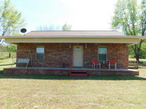 This house is a true jewel...cute as can be, and so clean it looks brand new! Beautiful kitchen that opens to the living room with 2 bedrooms and 1 bath. Bath has a large walk-in shower. Situated on 2.75 acres with outdoor storage.