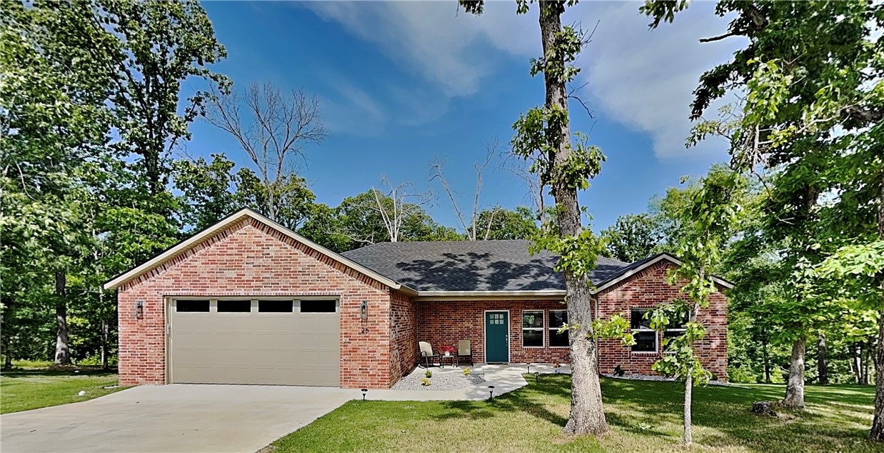 Enjoy the wooded view from the back deck of this gorgeous like-new home! This well maintained home is spread over two lots with mature trees giving you ample room and privacy. With tons of windows and a modern color palette you will love the bright and inviting space as you enter the home. The open living space has durable luxury vinyl plank floors and an airy chef's kitchen with gorgeous granite, plenty of cabinets and a pantry. This split layout home also includes a half bath that is perfect for guests. Storage is no issue as this home has lots of closet space. Step outside to the low-maintenance composite deck, protected by gutters with leaf guards, and enjoy the serene forest backdrop. The front porch offers a charming spot for morning coffee. The spacious, insulated 2-car garage comes with an electric vehicle outlet. Combining modern efficiency with a peaceful double-lot setting, this move-in ready home is truly a sanctuary. View the virtual tour now and then schedule your in-person showing! (2-bed septic)