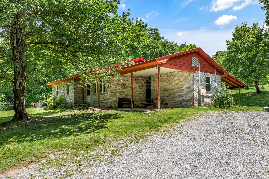 Located on a quiet dead-end street, this updated property offers the perfect blend of city convenience and peaceful country living! Situated on approximately one acre, the property features a detached pole barn with electricity, a charming old well house, a wet weather creek, and open, usable land and mature trees that provide privacy. Recent updates include new flooring, new windows, a new HVAC system, and a bonus heated and cooled space that adds flexibility for an office, hobby room, or additional living area! The home also includes paid-off solar panels for energy efficiency and long-term savings. Fruit trees and natural surroundings create a serene outdoor setting that’s hard to find. Paid off solar panels! No HOA!! Friendly egg-producing chickens are negotiable!!
