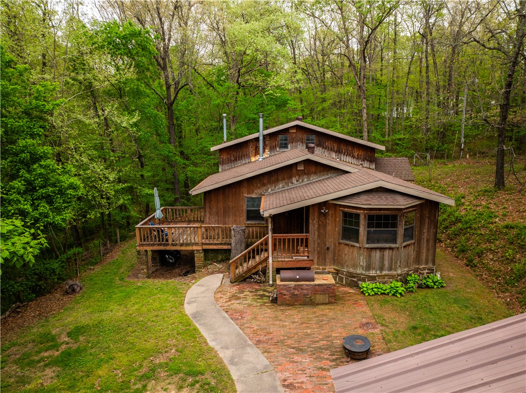 Spacious 5-bedroom, 2-bath home offering 2,116 sq ft on 2.17 acres of peaceful, tree-lined surroundings. Built with durable 2x6 exterior walls, this cedar home blends comfort, efficiency, and natural beauty. The open living area is filled with natural light and showcases scenic views of the surrounding landscape. Major updates include granite counters, a new roof, gutters, and chimney in 2020, providing added peace of mind. Outside, you’ll find a detached 2-car garage and a metal carport, offering ample parking and storage options. Enjoy the outdoors from the patio with a built-in BBQ pit—perfect for entertaining, relaxing evenings, or weekend gatherings. The acreage provides privacy and plenty of space for gardening, recreation, or simply enjoying the quiet setting. A rare combination of space, functionality, and privacy—this property is ready to welcome you home. May not go FHA, RD or VA- Cosmetic repairs may be desired. Selling AS-IS