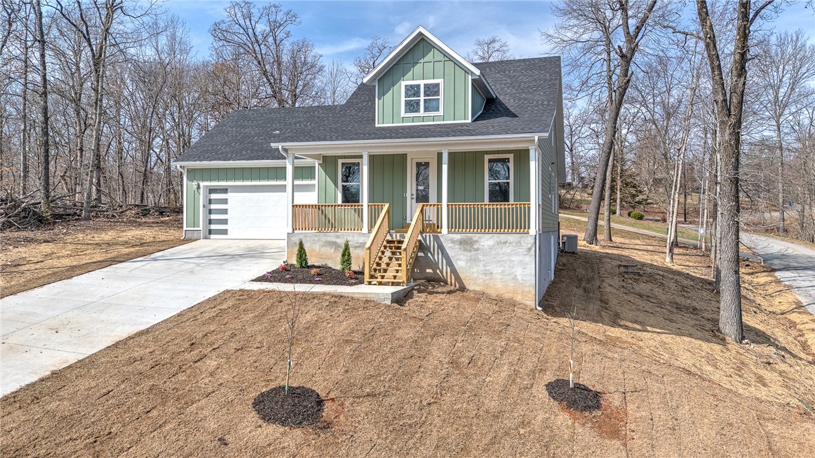Experience the best of Northwest Arkansas living in this stunning new construction home in Bella Vista. Inside, the home welcomes you with a bright and airy open-concept design that seamlessly connects the living, dining, and kitchen areas—ideal for both everyday living and entertaining. The spacious living room is the centerpiece of the home, highlighted by dramatic cathedral ceilings that create an expansive, light-filled atmosphere. The thoughtfully designed floor plan features a luxurious primary suite on the main level, offering privacy and convenience. Upstairs, additional living space provides flexibility for a media room, home office, playroom, or guest retreat—perfect for adapting to your lifestyle needs. With quality craftsmanship, contemporary finishes, and a functional layout, this home combines elegance and practicality in a beautiful Bella Vista setting. Enjoy peaceful surroundings, abundant recreation, and a vibrant community while living in a brand-new home designed for modern living.