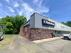 PRIME LOCATION & SUPERBLY CONSTRUCTED!!! Immediately off Exit 55-- this 7,500 square foot steel building is now for sale. First time on the market!  Free standing steel building is currently housing a Radio Shack, middle open unit, and an apartment. It is a 3 tiered structure. The interior walls can be removed to have an open structure. Incredibly priced, below market value, owner is ready for travel and adventure. See specific showing instructions in Private Remarks.