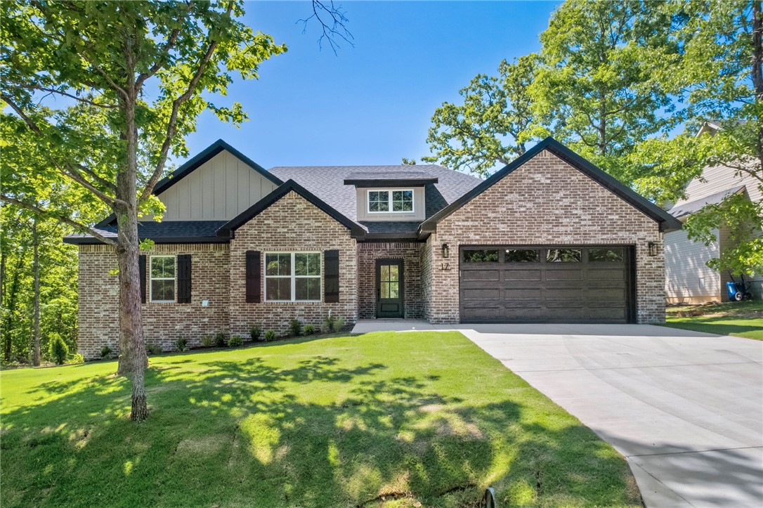 New construction on a .30 acre wooded lot down the street from Branchwood Nature Trail and Recreation Center! Easy access to I-49! Step inside to discover an inviting open concept design featuring beautiful floors that enhance the spacious feel of the home. The stylish kitchen is equipped with a gas range, 3 cm quartz countertops, custom cabinets, and a walk-in pantry. Entertain or unwind in the living area, complete with a stunning fireplace, or step out onto the HUGE COVERED PATIO to enjoy the peaceful surroundings. The primary suite features a large walk-in tile shower and closet. Buyer can receive $3,500 in closing costs when using the builder's preferred lender!  This Property is eligible for 100% financing with a USDA-RD loan (no down payment).  Ask your lender about it.