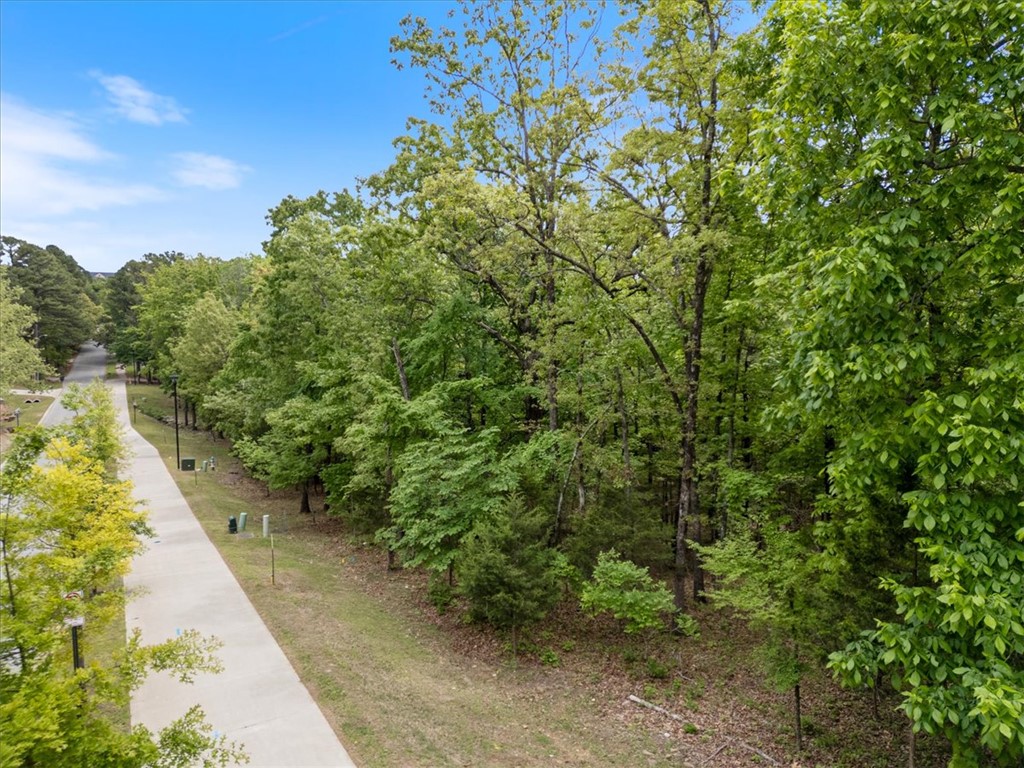 Prime 0.55-Acre Wooded Lot in Markham Hill.
This exceptional residential lot on W Markham Road in Fayetteville is ready for your custom home. Located in the coveted Markham Hill subdivision, you will enjoy immediate, natural seclusion on this gently sloping, tree-filled lot. An ideal location for building your dream home while being surrounded by the canopy of mature trees.  This established neighborhood features a complete utility infrastructure, including 6' sidewalks and classic street lighting along Markham Rd. Enjoy premier proximity to the University of Arkansas campus, downtown Fayetteville, The Stonebreaker Hotel, Markham Hill Nature Trails, and local recreational paths. This is an exceptional location for both commuters and outdoor enthusiasts within the Fayetteville School District. Buyer to connect to all utilities.