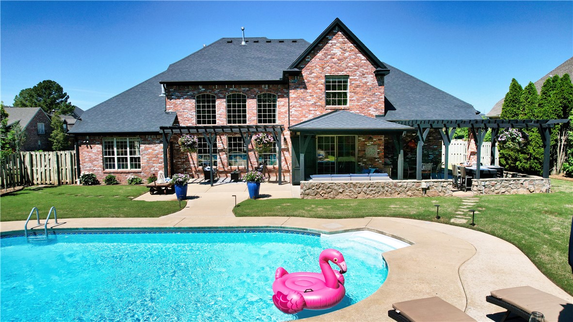 Imagine mornings bathed in natural light streaming through soaring, floor-to-ceiling windows. Evenings spent gathered around a crackling fireplace while the saltwater pool glimmers in the background. This resort-style oasis does not require reservations - just walk outside into your backyard. Tucked inside the gates of Shadow Valley Country Club & nestled along the prestigious Osage Creek corridor, this beautifully remodeled home invites you into a lifestyle where everyday luxury come naturally. This thoughtfully designed living space offers the rare combination of versatility and sophistication. The open-concept kitchen is a chef's dream with gas range, stainless appliances, walk-in pantry, quartz countertops, and a large island for hosting. The true showstopper is the private backyard. An entertainer's paradise - saltwater pool, covered patio, pergola, built-in bar, outdoor tv & woodburning fireplace all wrapped in mature landscaping & ambient lighting. Ask for Home Amenity List for more information.