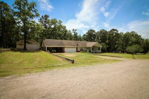 A perfectly, peaceful setting on 2 acres m/l. Just a few minutes from i40 makes this country home super convenient to either Russellville or Clarksville. Complete with a shop, carport AND garage, you'll have plenty room for any extra toys or machinery you may want. The split floor plan with an open kitchen/ living room area and deck off the back and a covered porch on the front means this home has a lot to love. Take a tour and imagine yourself calling this your NextHome.