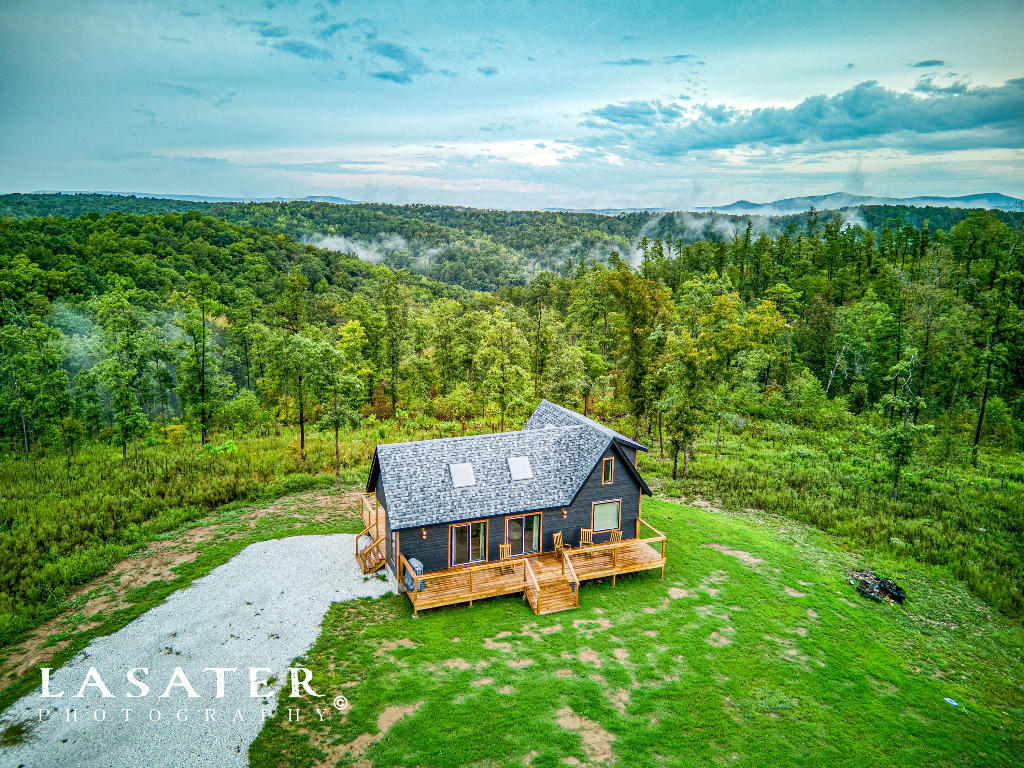 Escape to the tranquility of the Ozark Mountains with this newly constructed, luxurious cabin situated just minutes from the charming town of Jasper, Arkansas. Nestled on a spacious 3.07-acre lot, this cabin offers a perfect retreat for those seeking a blend of modern comfort and natural beauty. This cabin is newly constructed and thoughtfully designed to provide the utmost in comfort and style. Only a short drive away, you'll have easy access to the Buffalo National River, known for its crystal-clear waters, kayaking, and hiking trails. The cabin offers stunning views of the picturesque Ozark Mountains, allowing you to soak in the natural beauty of the region from the comfort of your own home. Don't miss your chance to make this cabin your own private getaway.
