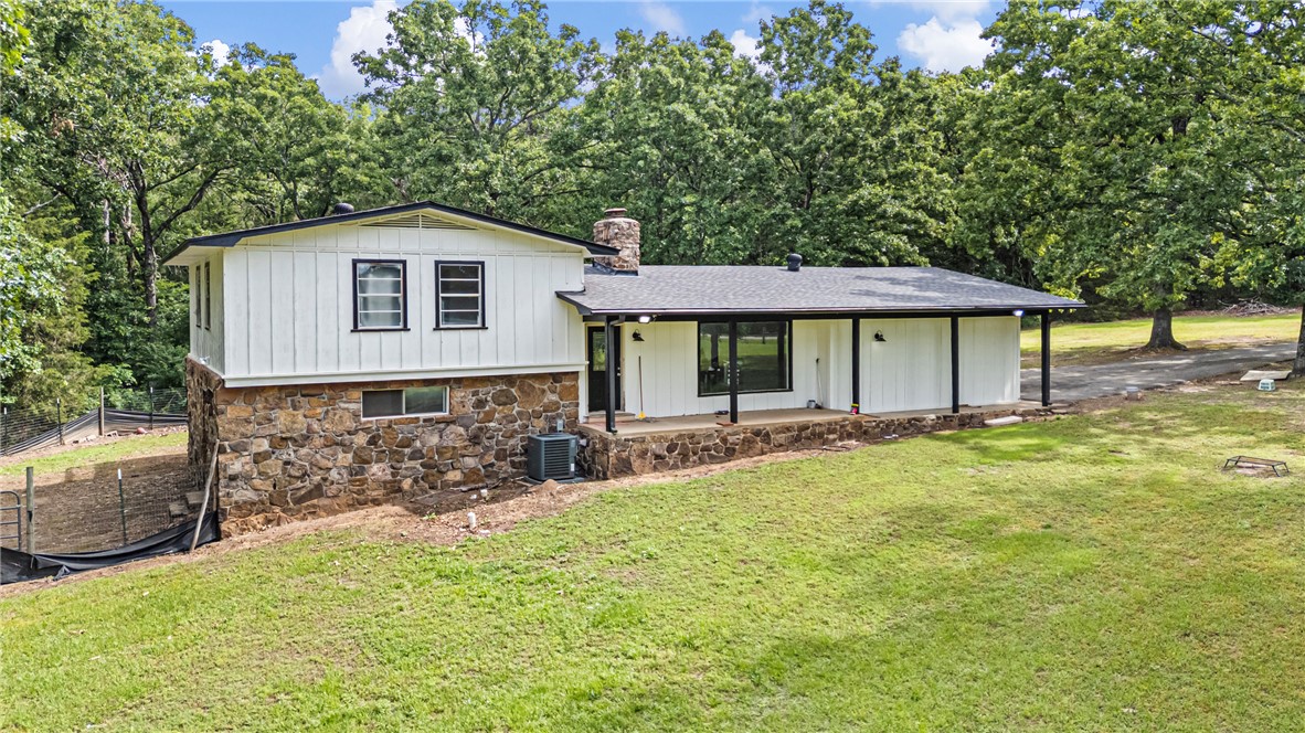 Completely remodeled and move in ready, this 4 bedroom, 3 bath home sits on 4.31 acres offering a mix of cleared yard space and wooded privacy. Two primary suites, one upstairs and one downstairs, provide flexibility for multigenerational living or guests.

Updates include new plumbing, HVAC, electrical panel, flooring, and fully renovated bathrooms taken to the studs. Roof is approx. 8 years old.

The garage was converted into additional living space, adding versatility. All appliances convey. Updated ceiling fans throughout and hardwired smoke detectors tied into the electrical system add safety.

Outside features include a large deck overlooking the acreage, full outdoor lighting, vapor barrier in crawl space, and a security camera system.

This property offers acreage, privacy, and modern updates in one package. Additional highlights include open layout, natural light, and peaceful setting close to town. A rare combination of updates, land, and convenience in one property!