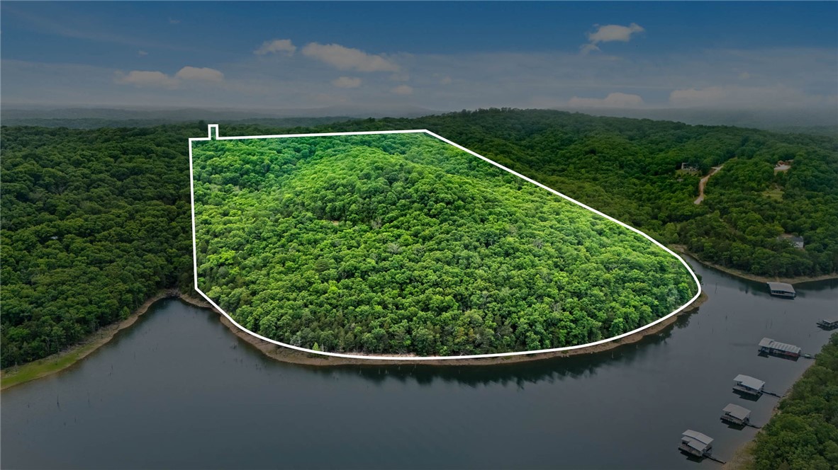 Discover an extraordinary opportunity in the heart of Beaver Lake. 47 acres offering a rare combination of panoramic lake view, and premier lakefront property with exceptional development potential. This unique property provides the ideal setting for a luxury residential development, private estate community, vacation retreat, or investment project. Rolling topography, mature timber, and multiple scenic building sites showcase breathtaking views of Beaver Lake from numerous vantage points. The lakefront acreage offers direct access to the shoreline, creating endless possibilities for upscale lakefront homes. Conveniently located near a marina, recreational attractions, and NW Arkansas amenities, a rare chance to acquire a large scale lake property in one of the region's most sought after destination. Potential uses include: Luxury Home Development, Private Gated Community, Short Term Rental. Rarely does a property of this size, beauty, and versatility become available on Beaver Lake. Endless possibilities await!