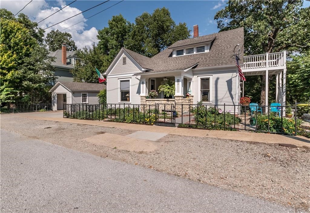 Beautiful, well maintained home located in the Heart of Historic Eureka Springs.  10 Ft. ceiling, hardwood floors, office, open kitchen, walk in shower, and screened in back porch with access to a beautiful large deck.  Large living room, dining room, and Master bedroom on the main floor.  2 bedrooms and 1 bath on the upper floor with a balcony off one bedroom.  Newer roof and Heat pump.  Well landscaped and within walking distance to downtown.  This updated 1920 home is worth seeing!  It is a beauty!