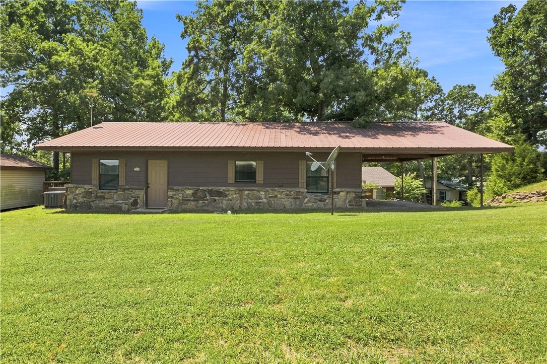 Experience the best of Beaver Lake living! This beautifully remodeled 2 bedroom, 1 bath home with sunroom and wood deck includes a boat slip in the community's covered dock, with easy access just a short distance from the home.  For added convenience, there is also a boat ramp at the end of the street, and you'll enjoy a view of Beaver Lake from the front yard. Completely renovated down to the studs in 2023, this move-in-ready home features all-new plumbing, electrical, appliances, and updated finishes throughout.  Whether you're looking for a full-time residence, weekend getaway, or vacation rental opportunity, this charming Beaver Lake home offers modern updates and easy lake access in a desirable location. Community boat dock dues are $750 annually.