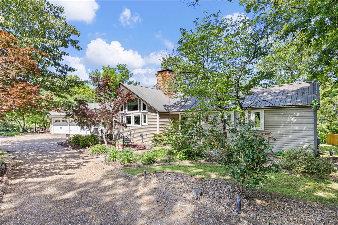 This pristine front yard sets the tone for your own private paradise. From the moment you step inside, the warmth and craftsmanship of this beautiful home are unmistakable. Floor-to-ceiling windows frame uninterrupted views, while soaring ceilings, exposed wood beams, and hardwood floors create an inviting, timeless atmosphere. The classic kitchen adds to the home’s enduring character, making every guest feel welcome.

The open floor plan allows the living room to flow seamlessly into the sunroom, offering abundant natural light and year-round comfort. Step outside to discover an inground pool and pool house—perfect for entertaining and destined to make your home the gathering place. A brand-new pool fence provides added privacy and safety, and newly built decks offer generous space for cookouts and outdoor living.

Just when you think this home has offered all it can, you’ll find a fully finished mother-in-law suite in the basement, ideal for extended family, guests, or additional living flexibility.