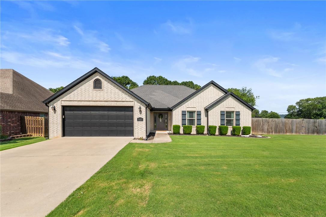 This move-in ready, one-level home in The Hamptons offers 1,822 square feet with a desirable 3-bedroom, 2-bath split floorplan. Upon entering, the spacious foyer opens to a cathedral ceiling Living Room with a stacked stone gas fireplace & large windows pouring in natural light. The eat-in Kitchen is perfect for everyday living & welcoming guests; complete with stainless steel appliances, pantry, bar seating, & a bright breakfast area. The generous Primary Suite features not one, but two walk-in closets, a soaker tub, shower, & double vanities! You'll be amazed by the size of this home's yard. The backyard includes a paved patio, garden bed, plenty of room for a trampoline, swingset, grilling, kicking a soccer ball...all with more room to spare! Looking for even more space? Rodney Ryan Park is at the end of the street! Additional highlights include quality brick & stone exterior and easy proximity to shopping, dining and the University of Arkansas.