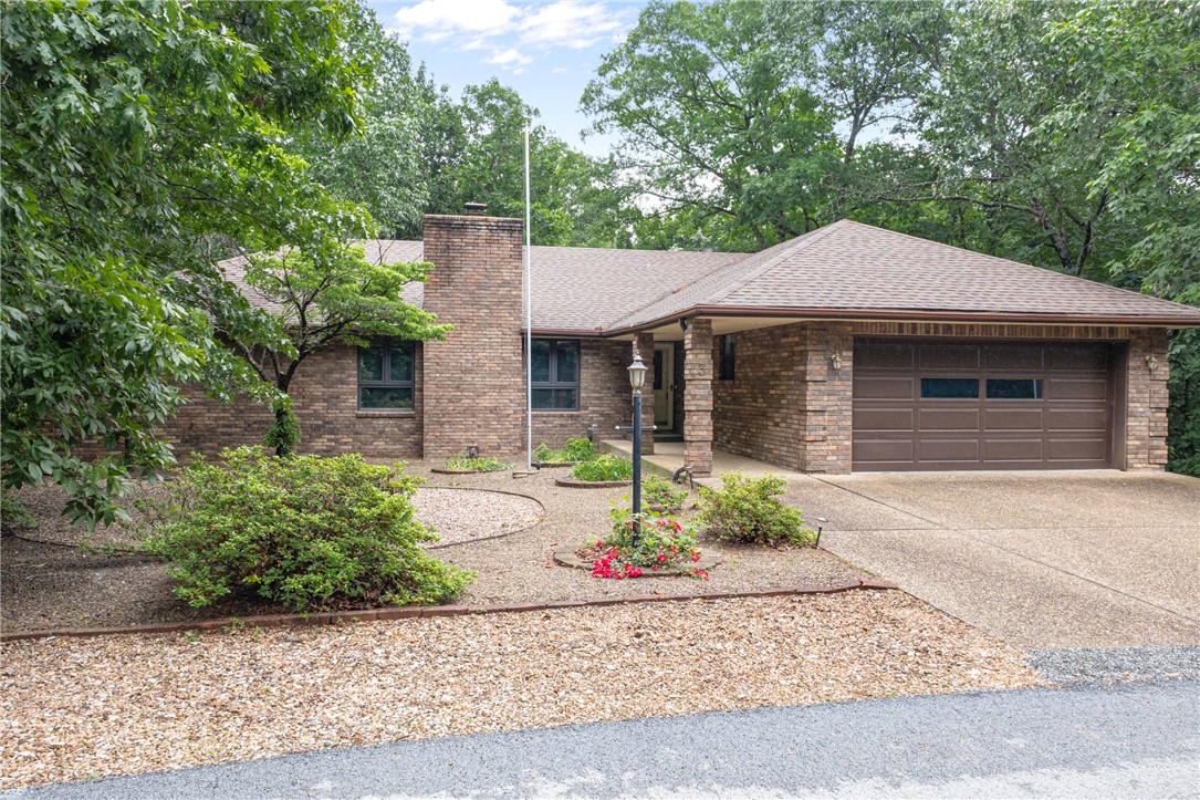 Beautiful Home in Bella Vista Near Amenities & Golf! This 3 Bedrooms home has been freshly painted throughout and offers spacious living areas and renovated kitchen. Foyer entry welcomes you home. Large living room has statement brick fireplace that is functional additional heat source as well. Dining room flows into the kitchen and is great for entertaining. Kitchen features beautiful granite counters along with stainless appliances and island with counter seating. Large sunroom is an amazing second living space and offers beautiful wooded views and natural lighting. Deck area off the sunroom provides spacious outdoor living. Primary suite has WIC and attached bath with soaking tub, shower, and large double vanity. Two guest bedrooms and guest bath. Detached shed offers extra storage or workshop space. Enjoy quick access to community amenities including gym, pool, trails, tennis, golf & more! Welcome Home!