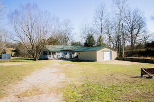Looking to live on the water?  Here's your chance.  Sit on the back deck and watch the water flow.  Peaceful location with abundant wildlife and beautiful views. This 2 bedroom, 1 bath home sits on 2.15 acres, has a year round creek and spring,  and is 10 minutes from town.  It has a 20 X 30 Shop with a garage and carport.  The seller states the water has never been close to the home but is within the FEMA flood plain. Water supply to home is spring with filtration system and pressure tank.