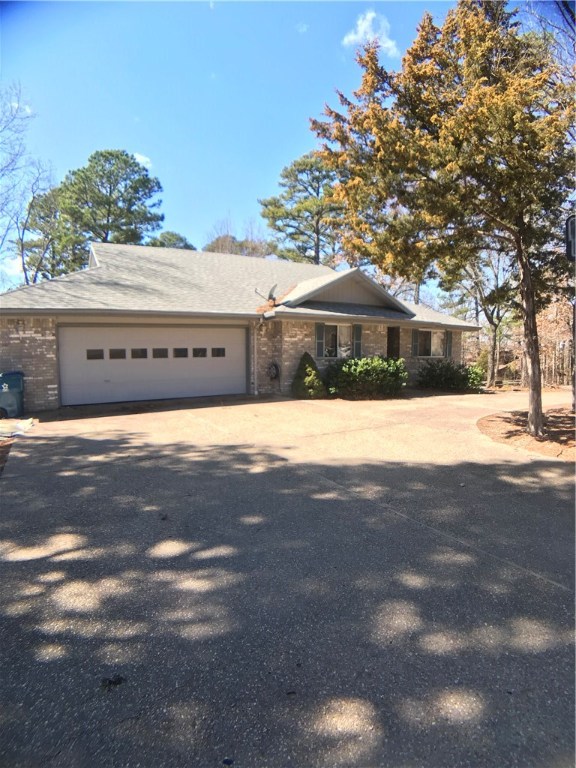 3640 SF, 4 bed 3.5 bath home located right in the heart of Bella Vista. Large eat in kitchen with tons of storage, 2 living areas, sunroom, beautiful wood flooring throughout main level.  Basement level has separate entrance, huge living area, kitchenette, full bath, large storage room, and workshop. Potential mother in law quarters or Airbnb. Brand new carpet. New heat & air system in 2016.New water heater in 2017. Adjoining lot included. Walking distance to trail head for the back 40. Cooper Elementary.