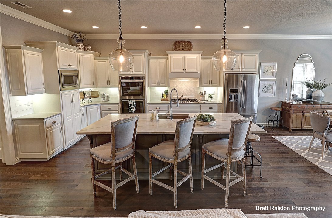 Don't miss this opportunity! This quality built home is full of designer touches and upgrades. Open floor plan. Gourmet Kitchen with gas cook top and quartz counter tops. Butlers pantry and a walk in pantry. Master suite is on the lower level with 3 additional bedrooms and 2 baths on the 2nd level.This home is designed for entertaining, both inside and our.  Covered patio with a fireplace, beautiful pergola and extended deck.  Extra storage, 3 car garage. Landscaped with irrigation.