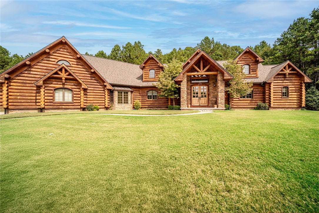 Experience the ultimate in serene country living with this charming log home nestled on 144 acres., but only minutes from shopping. Known as Sycamore Springs. Featuring a spacious shop and a tranquil pond. this property offers endless opportunities for outdoor enjoyment and farming. Behind a gated entrance lies expansive park like grounds which are perfect for hiking, wildlife viewing, or simply relaxing in nature. If you're seeking a peaceful retreat or a corporate getaway, this property provides the perfect balance of rustic charm and modern convenience. Matching Granite throughout the house and it has a Full house surround system. Wisconsin log home inside and out with a 6" insulated wall in between. Outdoor kitchen and a fountain. 40x60 workshop with cement floor, water and electric. Ideal for working, hobbying or storage.