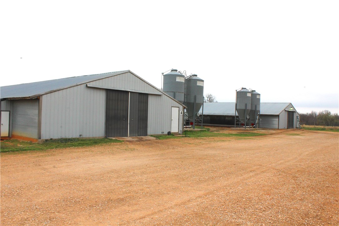 Location, location, location!  Let this 10 house Simmons broiler farm make you money!  Property is very well located and would be a great investment for future development.  Immaculately kept, natural gas, pasture for horses or cattle, eco drum, composter, litter shed, equipment shed, great office with bathroom and shower.  This farm is set up right, is a solid income producer and is ready to work for you! 3 bed/2 bath comfortable brick home. Roping arena, announcers stand, and arena lights are optional.