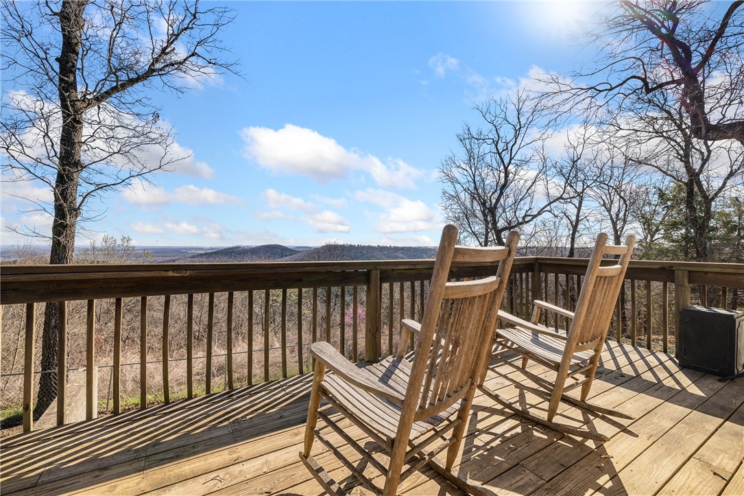 Play where you live!  Set on 52 m/l acres, this home & property offer the kind of freedom most people dream about. With 3 springs and a year-round creek, the land is alive with natural beauty and endless outdoor adventure. 3 miles of established trails wind through the property—perfect for ATVs, side-by-sides and mountain bikes. Wildlife is plenty, making this an ideal place to hunt deer, turkey, bear, and boar right on your own land.  The home, built in 2006,  offers 4 or 5 bedrooms and 3 full bathrooms. Enjoy incredible sunrise views of the mountains and vistas that stretch for miles.  Inside, you’ll find new carpet installed (2024). With 2,568 sqft on 2 levels, the walkout basement is perfect for guests or entertaining, featuring 1–2 bedrooms, the 3rd full bath, a second living area, wet bar, and additional storage room. Whether you're looking for a hunting retreat, outdoor playground, or peaceful place to call home, this property offers the rare opportunity to live, explore, and enjoy nature every single day!