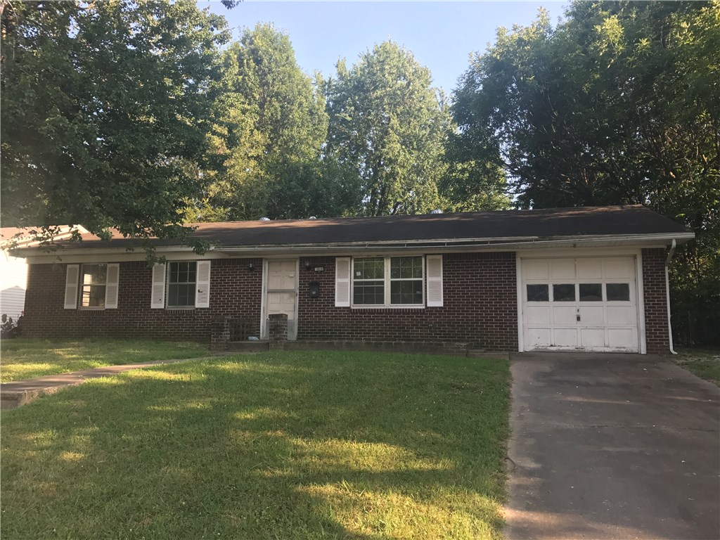 Spacious 3 bedroom, 1.5 bath home with lots of potential. Nice steps leading to the front door. Close to shopping and school. Extra storage space in the garage. Large backyard with storage building.