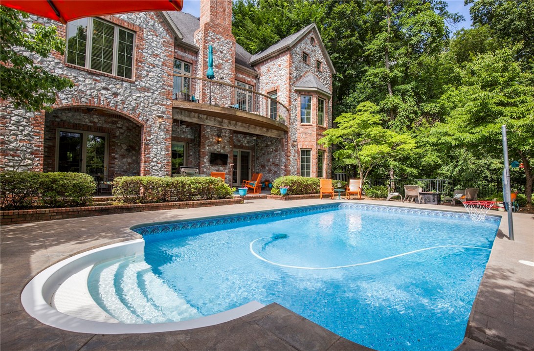 Custom home in desirable Hanover sub has everything you are looking for!  Open floor plan, Mstr suite and 2nd BR on main level, living room and updated kitchen that opens to upper deck w/ private views of your pool and tree lined lot, office, Bonus and Media rooms, game room, wet bar, safe room, covered deck and patios, private 5th BR and bath on lower level perfect for guests or that teenager plus 2 BR's up w/ their own baths!  Great location connected to trail system and only 2 miles from downtown!