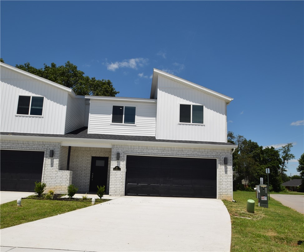 Call today for move in Special! New modern design duplex in the heart of Centerton and close to Schools! Also included brand new side by side stainless refrigerator, washer and dryer. This 3 bed 2 1/2 bath plan has an open living concept with tall ceilings and tons of natural light. Kitchen has granite countertops, stainless appliances, a large pantry, and a gas range. Primary bedroom is on the main floor and has walk-in closet. Two bedrooms upstairs with full bath and landing area. Luxury vinyl plank flooring throughout the 1st floor, 2" faux wood blinds, extra storage in the upstairs attic. Property has a private back patio and wood privacy fence. Owner must approve pets and no smoking.