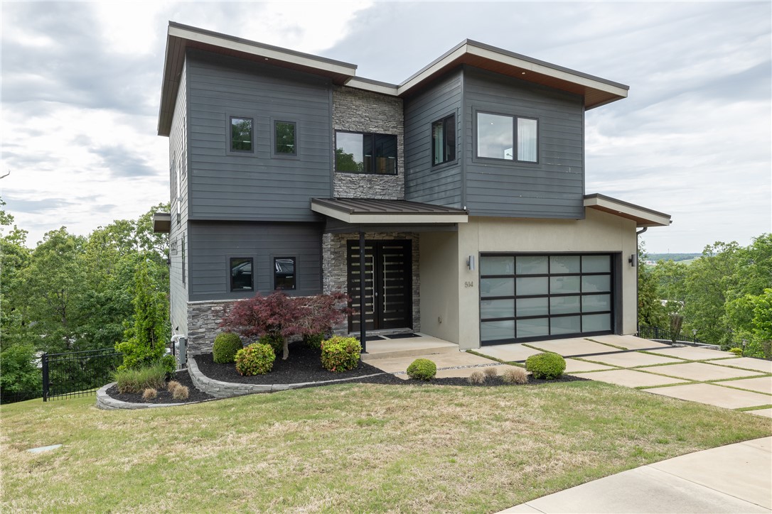 Step inside this modern, contemporary three-level home located in the heart of Fayetteville. Just up the street from shops, restaurants, & grocery stores, you can get anywhere in town quickly. Inside, you’ll find an open-concept layout with a gas fireplace in the living room & a kitchen featuring a gas range top, double oven, & a large island. Whether you’re cooking or relaxing, the expansive panoramic windows offer beautiful sunset views. Upstairs, the primary suite enjoys those same sunset views, along with a double head shower, stand-alone tub, & double vanity, plus another bedroom, bathroom, & laundry room. The basement includes a second kitchen & living room, along with two additional bedrooms connected by a jack & jill bathroom. It’s a perfect space to entertain, set up a game room, or simply relax. If you’re looking for incredible views in the heart of Fayetteville, you don’t want to miss this opportunity to make this home yours!