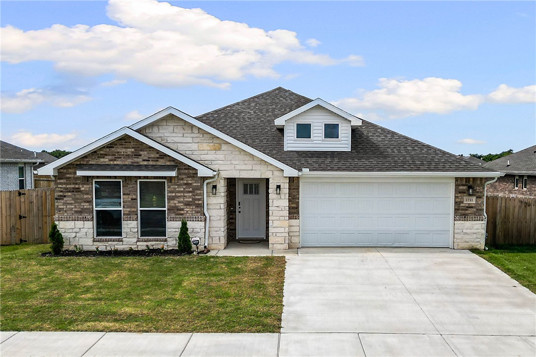 Meticulously maintained, this like-new home offers bright, inviting spaces and a functional open-concept layout. LVP flooring flows through the main living areas, complemented by granite countertops, LED lighting, advanced insulation, a coffee nook, and walk-in pantry. The kitchen, dining, and living areas flow seamlessly together, creating an ideal space for everyday living and entertaining. The spacious primary suite features a walk-in closet, walk-in shower, and dual vanities. Bedrooms two and three each offer walk-in closets with built-ins, with a full bathroom conveniently located between them. A pocket office provides additional storage/workspace. Additional features include blinds, gutters, a utility room with overhead cabinetry, and a built-in drop zone near the garage entry. Enjoy the covered back patio overlooking the fully fenced backyard with a 5x5 shed and 8x6 greenhouse. Conveniently located 15-20 min. from I-49, 5 min. from downtown Pea Ridge, and 10min. from Pea Ridge National Military Park.