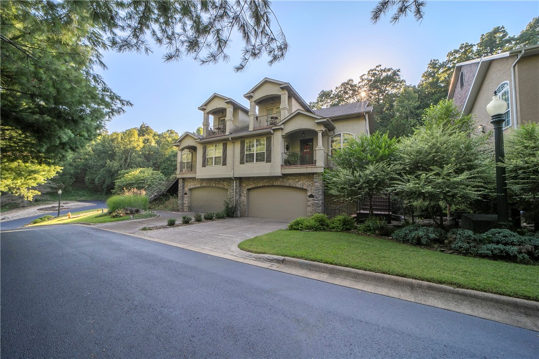 This place is a stunner! Nestled in the trees on a private drive you'll find this beautiful property! Featuring 3 BR/3 BA, formal dining/sitting room/office space, elegant social areas- including the living room that opens to the kitchen and breakfast area- accented with extensive crown molding. The kitchen features top of the line appliances and new quartz counters w/plenty of room for gathering. Bonus room with a bath that could be another bedroom, 2nd living space or both. Bonus Room BONUS...a huge storage room and walk-in attic w/nice storage as well. Garage, w/storage closet, is on ground level, main living and BR's on 2nd level, and Bonus on 3rd. Take the elevator from ground level to the 3rd. Load your groceries on the elevator to take to the kitchen. So convenient! All NEW- hardwood floors, some paint, quartz counters in the kitchen and gas log insert . Close to Bark Park, Razorback Greenway, new bike lift, Oz Trails, Crystal Bridges, DT Bentonville and new Wal-Mart World Headquarters!