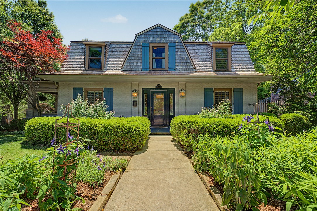 A timeless historic home in a prime, central Fayetteville location. Featuring classic Tudor-style architecture, this charming cottage offers 3 bedrooms and 2.5 bathrooms, thoughtfully designed with inviting living spaces and beautiful curb appeal. The covered side porch with built-in seating welcomes you home, perfect for relaxing and enjoying the professionally landscaped yard. Inside, upgrades throughout the home showcase warmth and charm, while offering functional living for modern lifestyles. The property includes a gated entry to the garage, adding both convenience and privacy.  Ideally located in the heart of Fayetteville, this residence provides easy access to trails, dining, and the University of Arkansas. Don't miss this rare opportunity to own a piece of Fayetteville history with character, charm, and an unbeatable location.