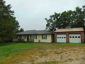 Nice home including 5 acres m/l mostly pasture with highway frontage and county road frontage. 3 Bed, 2 bath with unfinished basement plus 2 car detached garage. Propane tank convey's with property