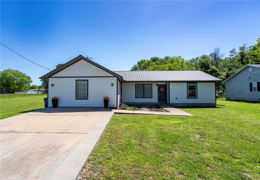 Check this beautifully updated 4-bedroom, 2.5-bath home situated on a spacious 0.44-acre lot in Gravette! This move-in ready home combines modern updates with a designed layout that offers both functionality and flexibility. With durable luxury vinyl plank flooring throughout, updated lighting, neutral paint tones, and a bright, cohesive design that feels both warm and modern. The kitchen features painted cabinetry, stainless steel appliances including an over-the-range microwave, dishwasher,and gas stove, with ample cabinet storage. The home also features a large laundry area with cabinetry for extra organization, with a durable metal roof.
The fourth bedroom includes a half bath, making it ideal for a guest suite, home office, playroom, homeschool space, or second living area. The master suite offers its own full bath and walk-in closet.Enjoy the oversized backyard with room to garden, entertain, play, and a rare find within city limits. Conveniently located near schools, parks, and this home will fit your needs.