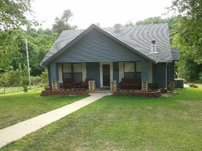 Great Hunting/Cattle Place! Only 5 miles from Hwy 412  bypass, abundance of deer 2 springs, cleared fields/views, old barn, chicken barn/hay storage, 2 pads, 20x40 cement slab**Historical home, well maintained, basement as workshop/storage. Views of deck.100 acres