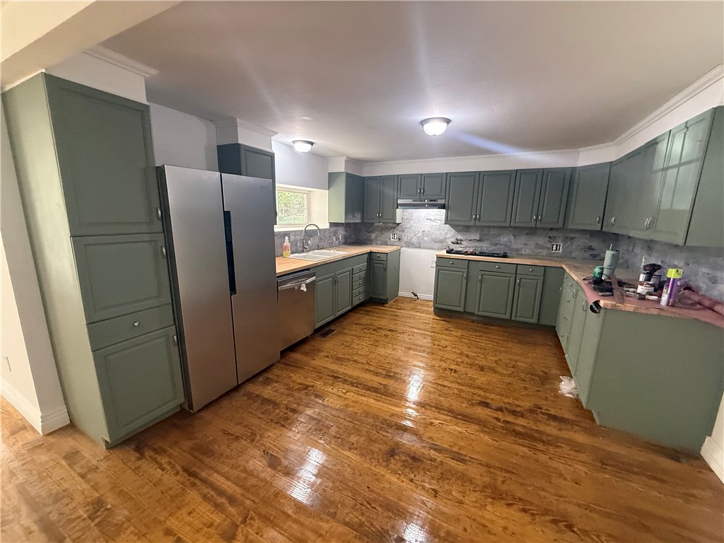 Charm meets craftsmanship in this beautifully remodeled 1885 log cabin turned traditional home in historic Winslow, AR. Nestled in the Ozark hills, this 3-bed, 2-bath gem blends old-world character with modern comfort. The original log structure delivers exceptional insulation, boosted further by 3" of fresh attic insulation just installed. Real hardwood floors, refinished during the remodel, run throughout. A flex space with its own exterior entrance is perfect for a home office, studio, or guest suite. Propane feeds the furnace and is stubbed for future use. Outside, mature trees shade a level, lush yard, and a hand-built rock wall with stone steps adds timeless character. The attached carport offers abundant storage above. Enjoy easy access to scenic Hwy 71, with I-49 just 5 minutes up the hill. Whether you want a full-time residence or an escape from crowded city life, this move-in-ready home pairs preserved history with modern upgrades in one of the Ozarks' most charming towns. Schedule your showing today!