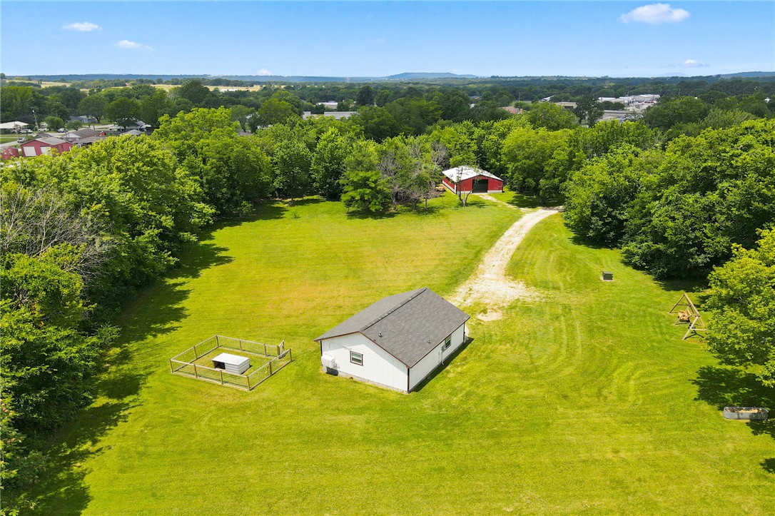 Rare opportunity to own a true "paradise pocket" in the heart of small-town Lincoln! This unique property includes three connected parcels totaling 2.64 cleared, level acres with endless possibilities. Zoned for both R-1 single-family and R-2/duplex development, it's ideal for your dream home, investment, or future expansion. The property features a 720 sq. ft. tiny home built in 2021 with a stunning marble-style epoxy-coated concrete floor, expansive open space, and gorgeous claw-foot tub in the spacious bathroom! Even better, it's already framed to be converted into a garage if you choose to build a larger home. Also included is a spacious 1,200 sq. ft. insulated metal shop, providing abundant storage, workspace, or hobby space. Enjoy the privacy and peaceful setting while being just minutes from schools, parks, and downtown conveniences. Opportunities like this are hard to find! Also listed as Residential MLS#1354613
