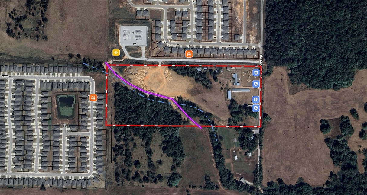 Exceptional 24.65-acre parcel, half a mile from XNA airport. Major subdivisions surrounding, municipal water main along the eastern boundary, complete with three water meters and a fire hydrant. Two sewer lines. hundreds of loads of concrete and red dirt fill added to elevate the northern section of the property, providing a level building surface. wooded ridge in the southwest corner offers the perfect backdrop for larger, custom wooded lots, while a cleared area near the creek along the southern border presents a fantastic opportunity for a neighborhood playground or nature retreat. Carroll Electric substation bordering the property to the northwest, transmission line running along the far western edge. private well with a backup generator, outbuildings for storage during development. 1500 sq ft 3bd/2ba modular home and a 600 sq ft 1bd/1ba tiny home, both with power, water, and septic—a perfect setup for site offices or temp housing for contractors. Highfill city limits, Bentonville address and schools.