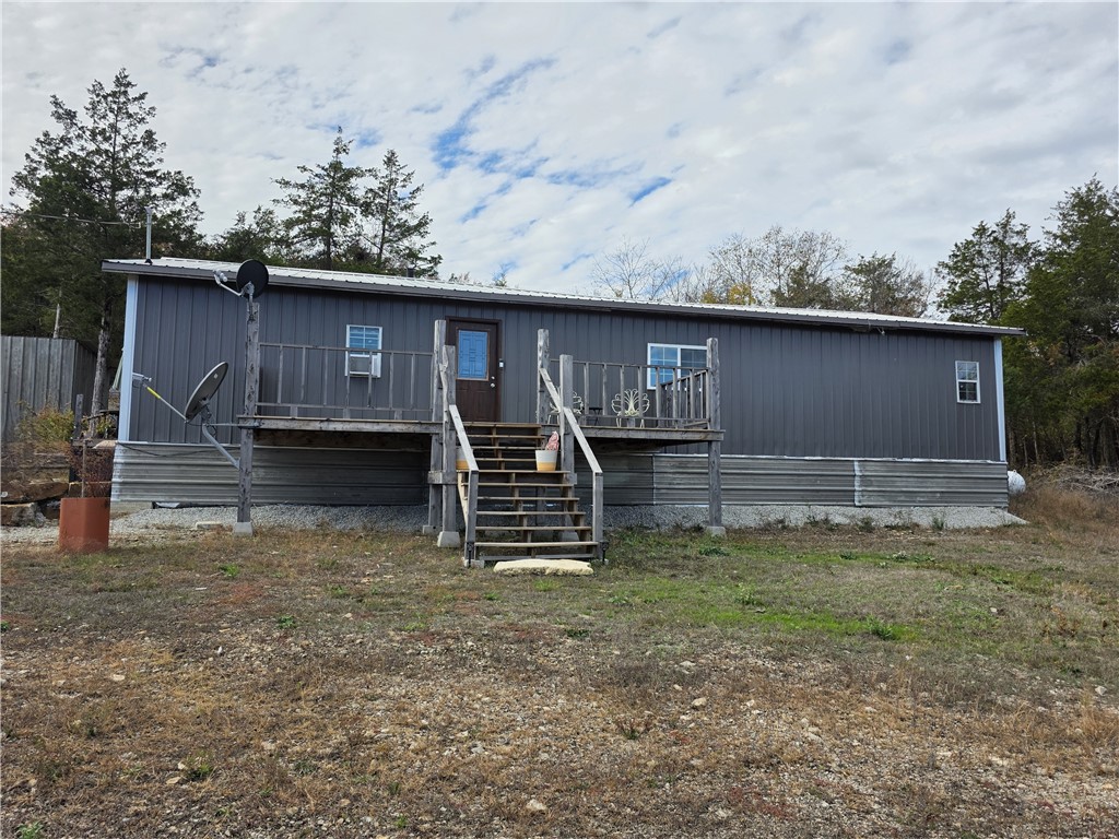 Built in 2022, this peaceful cabin-style home features 4 bedrooms, 2 full bathrooms, and 1,568 sq ft of living space on one level, with a split bedroom floor plan. Features include cedar-lined ceilings, vinyl flooring, a wood-burning stove, an open kitchen/living/dining area, and a large front deck for sunrise views.  The property sits on approx. 1 acre with a private well, workshop with electric, and an RV pad with electric, water, septic, and 50-amp hookup. Survey completed and corners marked. Just minutes to Bull Shoals Lake access for boating, fishing, and swimming. Enjoy quiet country living close to the lake!