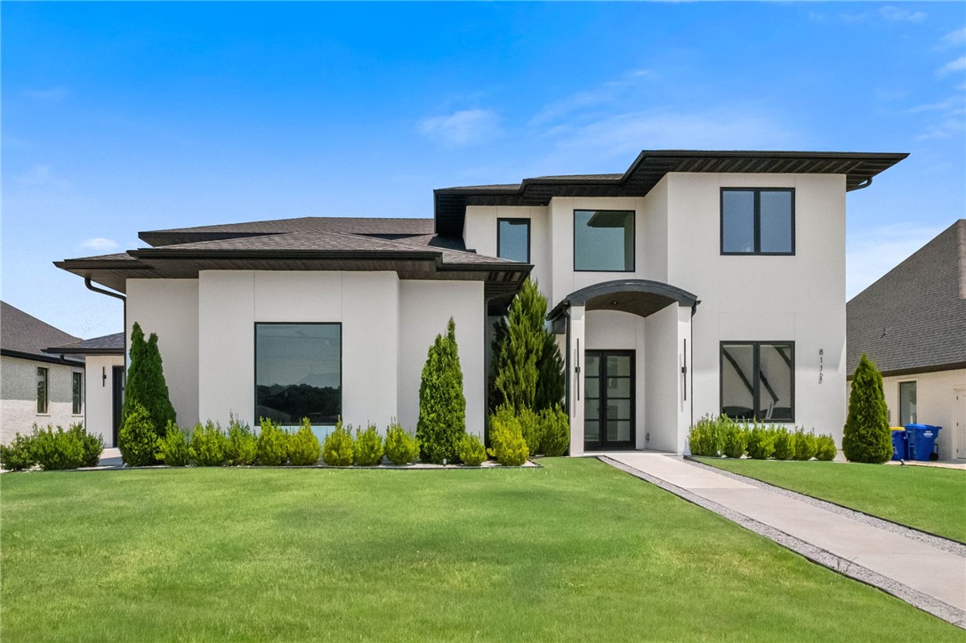 Modern luxury meets resort-style living on the Shadow Valley Golf Course! Built in 2022, this custom 3,593 SQFT home offers 4 bedrooms, 3 full baths, 2 half baths, an office, and a bonus room. Over $200K in upgrades include floor-to-ceiling windows with fairway views, wood floors, glass stair rails, quartz countertops with matching backsplash, waterfall island, oversized professional refrigerator, and two dishwashers. The resort-style backyard features a heated saltwater pool, spa, textured cooling concrete, outdoor kitchen with grill, refrigerator, oversized island seating 8, outdoor bath, and storage. Additional upgrades include glass garage and front doors, exterior stucco, electric blinds, built-in office, tornado shelter, and sliding glass doors. Transferable social, tennis, and golf memberships included. Located in the Bentonville School District on a quiet cul-de-sac, this is a home where mornings begin with fairway views, afternoons are spent poolside, and evenings are made for gathering.