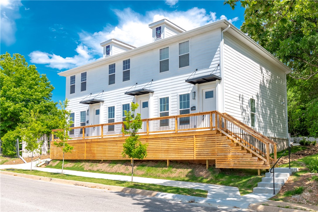 Prime Investment opportunity just down the street from U of A campus, Football Stadium, and Bud Walton Arena!  This brand-new triplex is fully leased with tenants moving in August 1st, 2026.  Annual Gross income of $75,600 for first year.  High potential to increase income year over year.  All three units are 2 bedrooms, 2.5 baths with an open-concept flow. The well-equipped kitchens feature a large island with sleek quartz counter tops, top-tier stainless steel appliances (including fridges), and custom ceiling-height cabinets.  Other features include: durable Luxury Vinyl Plank flooring throughout with tile accents in the bathrooms, all bedrooms upstairs with their own private bathroom, Walking distance to Razorback Stadium, Bud Walton Arena, intramural fields, and so much more!  Fridge, washer, and dryer included for each unit