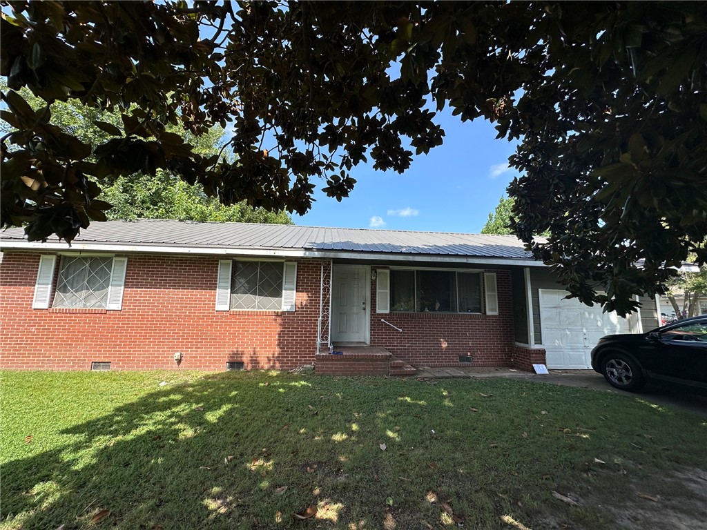 Calling all investors! Property needs interior attention, but has tremendous potential! Large corner lot and all brick exterior with good structure. 3 bedroom and 1 bathroom with large living room that opens up to the kitchen and dining room. Gas hook up in living room for small space heater hook up. Laundry room in separate room in the garage. New hot water heater in 2026, roof replaced in 2025. Exterior of the home was painted in 2025. Seller has had plumbing lines evaluated and added new toilet and pipes under the sink. Bathtub is cast iron tub. Front step railing has a handrail is in the garage. Seller removed railing to clean out property. Screws for the railing are included.  Pest/ termite policy has been in place.  Home is sold "AS IS" with no seller repairs/ credits being offered. No seller's property disclosure as seller has not lived in the property.  Buyer to verity taxes before purchasing. True fixer upper with lots of potential to the right investor/owner.