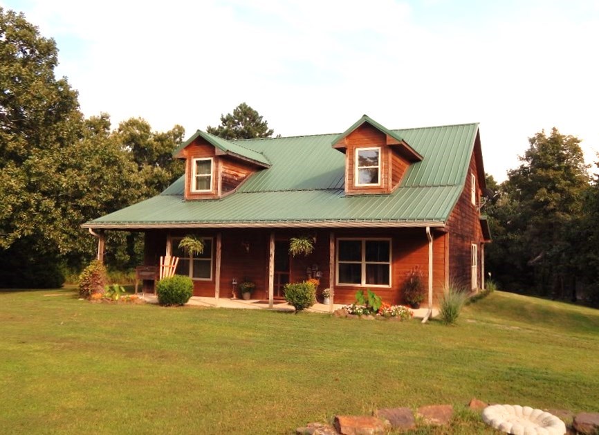 Country home with lots of character on 1 acre of land with privacy that offers 3bed/2bath, master bath with walk in shower and whirlpool garden tub, all electric, approx 2,000 sq feet, loft for office space, rural water, stained concrete floors, 6 inch cellulose insulation, open porch on front and back of the home,  30x50 outbuilding could be used for storage or shop with concrete floor, electric available and plumbed for future use. Pole shed 8x14. Split AC/Heat units for upstairs and downstairs.