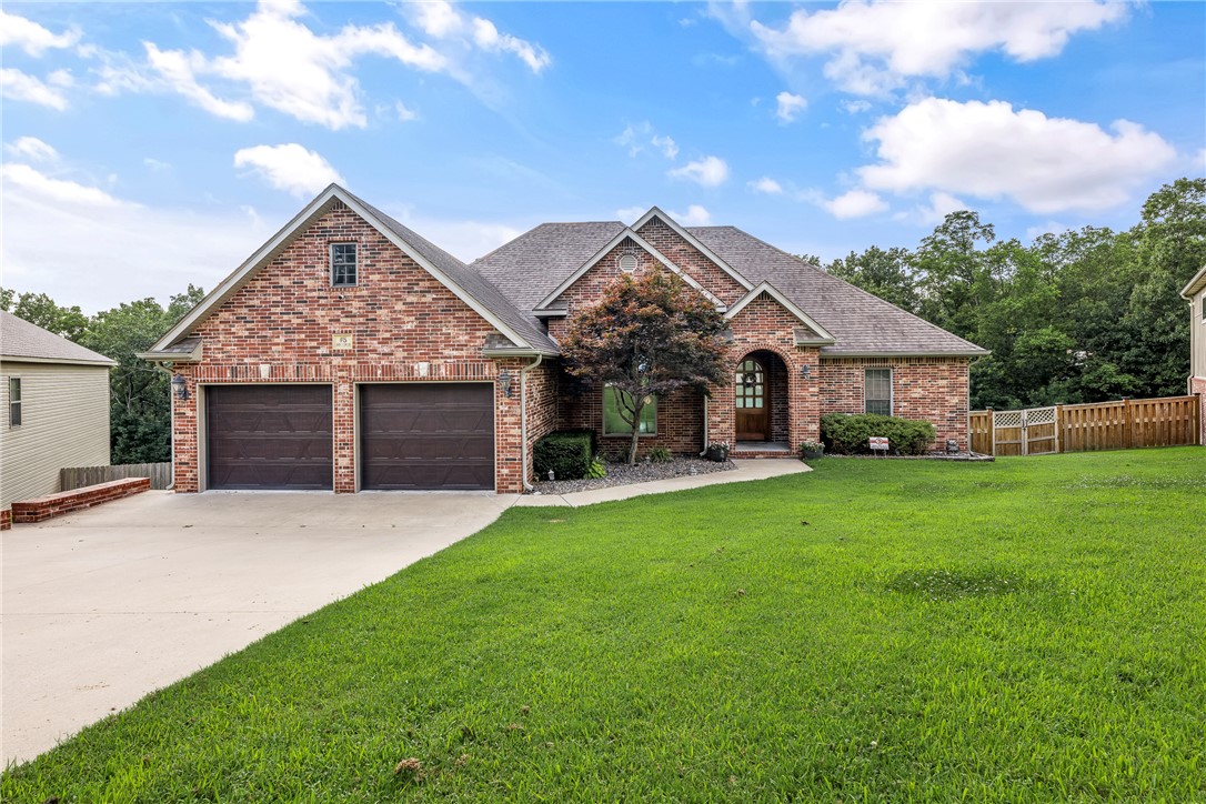 This stunning 2-story home blends comfort, style, and incredible entertaining space just minutes from Highway 71. The main level offers a bright open layout with a split-bedroom floor plan, abundant natural light, and an upstairs kitchen featuring granite countertops, upgraded stainless steel appliances, and generous pantry storage. Just off the kitchen, the lower level feels anything but below grade with large windows, 9-foot ceilings, a full second kitchen, built-in speakers, projector, and remote-controlled screen - perfect for movie nights or game-day gatherings. A spacious bonus room with double barn doors serves well as guest space, gym, or flex room. Hidden safe/tornado/storage room. The showstopper? A 1,200 sq ft detached garage with a 14-foot door, ideal for an RV, workshop, or extra toys.