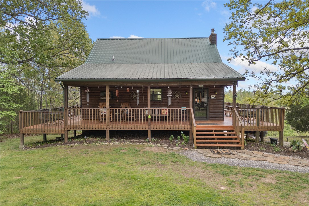 If you’ve been dreaming of a peaceful retreat with unforgettable views, this 3-bedroom, 2-bath log cabin on over seven park-like acres delivers. A full four-sided wraparound porch offers stunning views of the Tyler Bend area of the Buffalo National River. The lower level of the home features a bedroom/family room combo with its own kitchen and private outdoor access, ideal for guests or multi-generational living. Located just five minutes from Gilbert and Grinder’s Ferry access and moments from Tyler Bend, you’ll enjoy easy access to some of the river’s most loved destinations. You’re also just minutes from local favorites—Ferguson’s Country Store and Coursey’s Smoked Meats.
Extras include an RV hookup, two-car carport, outbuilding, and shed. Whether you're looking for a full-time home, weekend getaway, or investment, this one checks all the boxes.