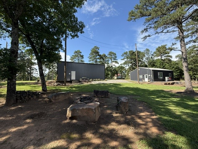Escape to your private retreat minutes from a public boat ramp on Lake Dardanelle. This unique property is ready & waiting to become whatever you desire-a weekend getaway, full-time residence, income-producing rental, or lake enthusiast's headquarters. The 35' x 40' shop featuring two 12-foot roll-up doors, is perfect for storing boats, RVs, a workshop, and gear. With 220 power, 2 electric meters, and a well, the possibilities are endless. Ideal for a barndominium conversion or a live-work space tailored to your needs. The climate-controlled 780-square-foot office space would make a cozy Tiny Home, guest quarters, or apartment.  Established garden space, abundant wildlife, peace & privacy with no through traffic. Whether you're a snowbird seeking escape, an RV traveler looking for the perfect home base, or a lake enthusiast wanting quick access to the water, this property offers the flexibility, functionality, and tranquility you've been searching for.Bring your vision and make this one-of-a-kind property your own.