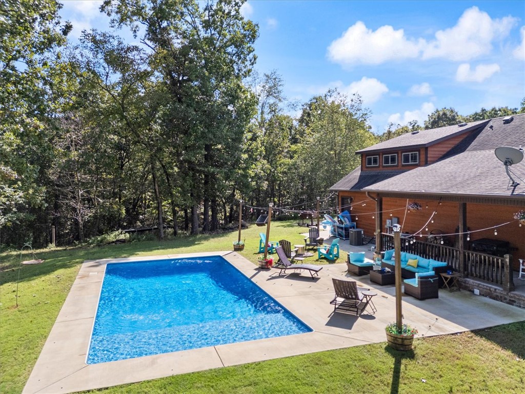 Welcome to your private retreat just minutes from town! This spacious 4BR/3BA home sits on 5 secluded acres, offering the perfect blend of comfort, convenience, and luxury. Inside, you’ll find a thoughtfully designed layout featuring a bonus room ideal for entertaining, a dedicated office for remote work or study, and a walk-in pantry with easy kitchen access. A built-in mud area adds everyday functionality, while the in-home safe room provides added peace of mind. Interior walls are insulated for soundproofing and energy efficiency, complemented by radiant floor heating throughout. Step outside to enjoy your own in-ground mineral pool—perfect for low-maintenance relaxation. Additional land available.