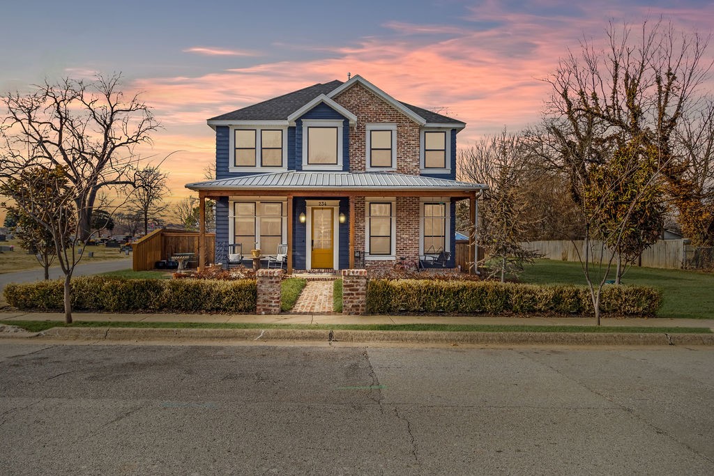 Modern home with vintage touches and classic styling. You won’t find another jewel like this, especially not with a nearly 1400 SF heated and cooled garage/shop in downtown.  Main home is 2,732 SF. Natural light throughout with big windows and transoms, trimmed inside & out with the wonderful architectural details you just don’t find anymore. Every door in the house is antique and flooring is real wood like homes had a century ago. Downstairs master suite features his & her closets, walk-in shower for two, fabulous vanity. Upstairs includes four bedrooms, big game room, and two full baths accessorized with vintage blue & pink fixtures. Bedrooms upstairs each have unique feature, one with a secret room above the closet! Large covered porches, reclaimed brick from 1800s cotton mill, gas lamps, private no-maintenance turf backyard w/hot tub. Tons of storage space in decked attic, and walking distance to square! Seller is related to List Agent.