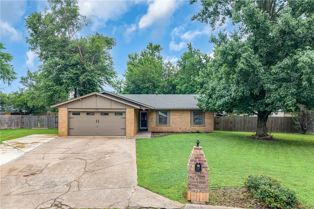 Okay, you have to hear about this one! A single-owner brick ranch-style home sitting on almost half an acre at the end of a cul-de-sac in Rogers — and the price will surprise you. This place has been well loved and it shows. Nearly 1,400 square feet with 3 bedrooms, 2 baths, a wood-burning fireplace, and a backyard that is seriously hard to find at this price point. The eat-in kitchen has a glass cooktop, dishwasher, microwave, and vent hood — all the good stuff. Walk-in closets, ceiling fans, new roof in 2022, and two detached storage buildings out back. Location is super convenient too — close to parks, schools, shopping, and walking trails. One owner, all brick, huge yard, cul-de-sac street. Honestly? Go see it before someone else does!